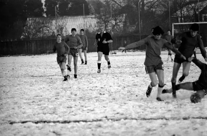 Framed Print : Sport Amateur football youth game in action in the snow near Maidshow between two local
