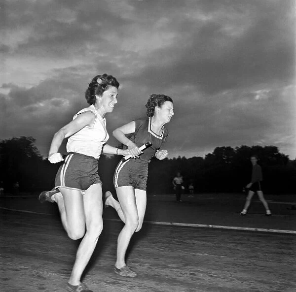 Sport Athletics: Jean, farthest from camera, taking the baton from Jean Foulds in a