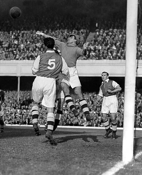 Sport - Football - Arsenal - George Swindin, the Arsenal goalkeeper punches the ball