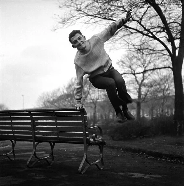 Sport. Football. Liverpool player Steve Peplow leaps in the air by a bench in the park