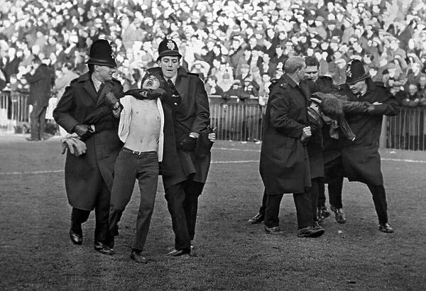Sport - Football - Swansea Town - Policemen drag two fans from the field during the game