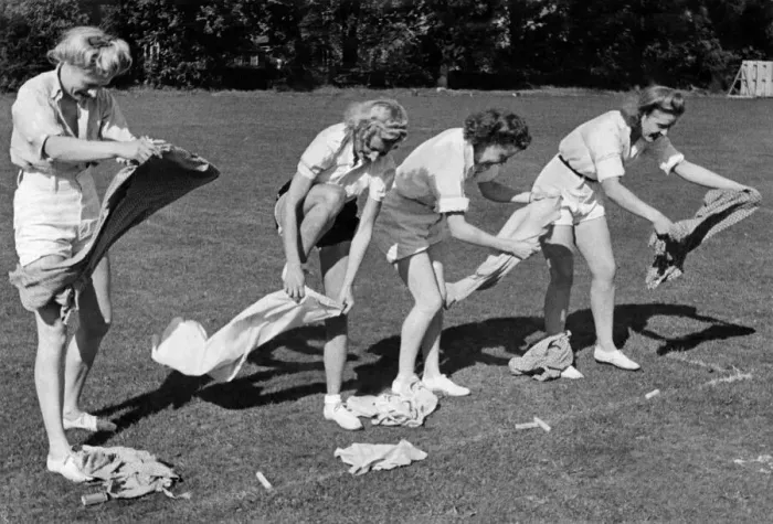 Framed Print : Sports Day Firewomen having fun in the dressing up race seen here hastily changing Framed Print : Sports Day Firewomen having fun in the dressing up race seen here hastily changing