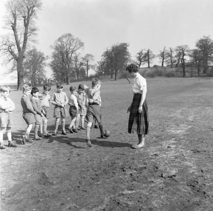 Framed Print : Sports mistress, Miss Reid, teaches football to the boys of Park Hill School, Kingston