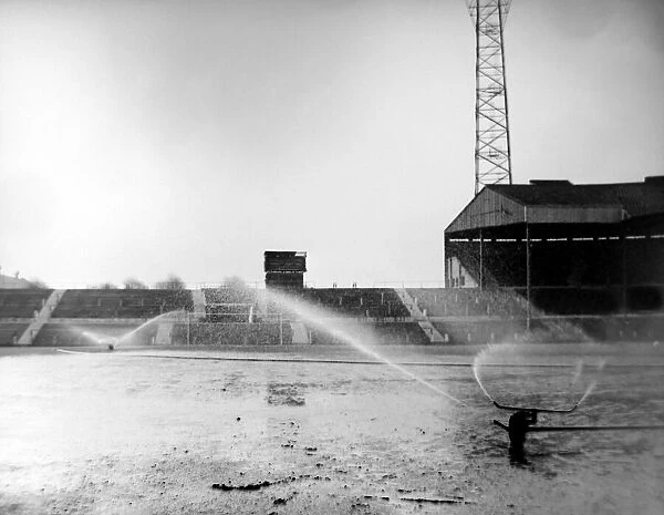 Sprinklers soften the turf at Old Trafford for the European Cup match against Real Madrid
