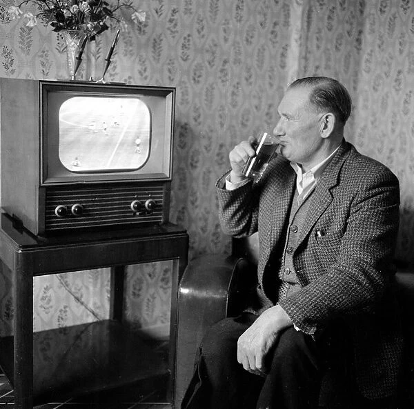 Former Spurs footballer Jimmy Dimmock seen here at home watching his beloved Spurs