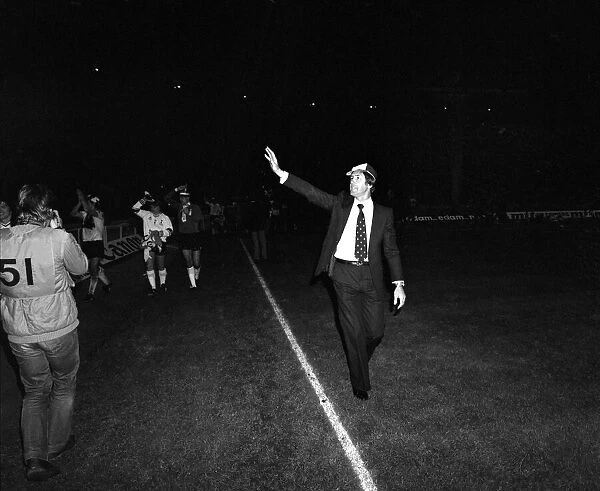 Spurs Manager Keith Burkinshaw walks around Wembley acknowledging the fans with the team