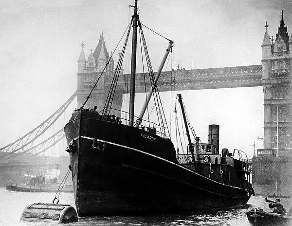 SS Picardy, moored next to Tower Bridge with a police boat in the Pool of London