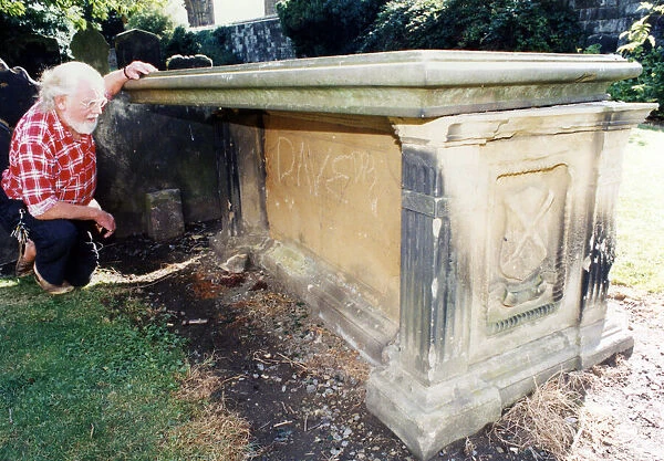 St Nicholas church tomb, church warden Ken Brookfield examines a tombstone in