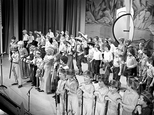 The stage is full of children during a performance by scouts