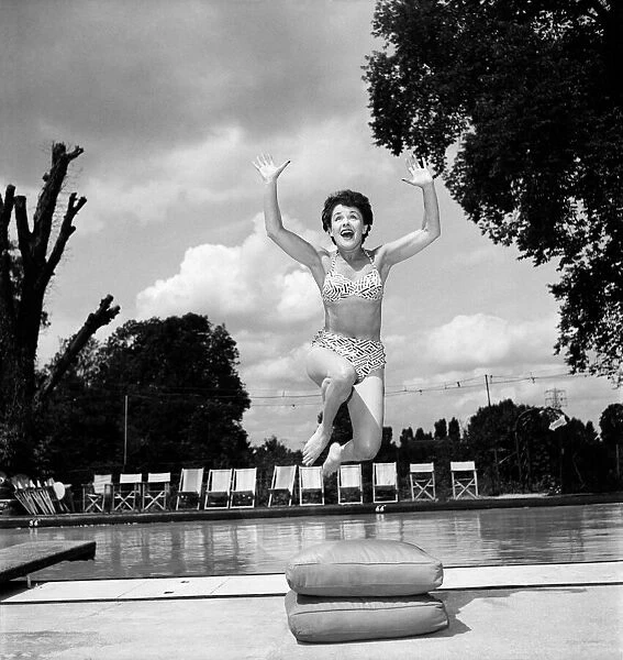 Stage and film actress Betty Paul wearing a bikini by the pool
