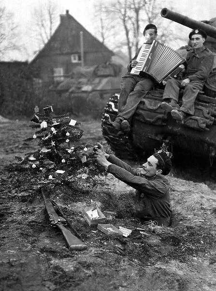 Stanley Kerr of Liverpool decorating his little christmas tree besides his trench in