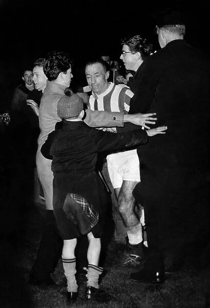 Stanley Matthews is mobbed by fans and supporters at Stoke after the game