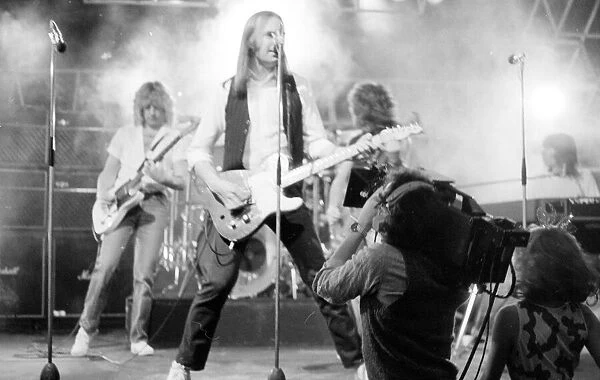 Status Quo performing on stage on BBC TV Programme 'Top of the Pops'March 1982