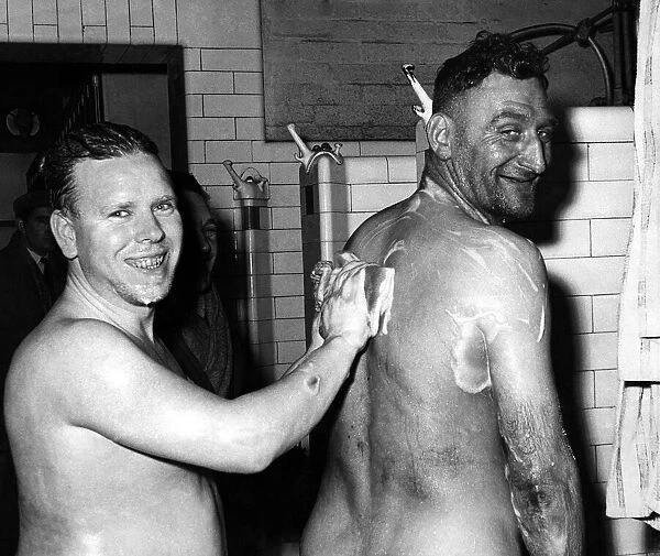 Stay-in strikers return. John James washes the back of his friend Arnold Moyle