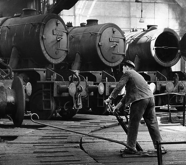 Steam Trains. A driver prepares to take his engine out of the sheds at the British
