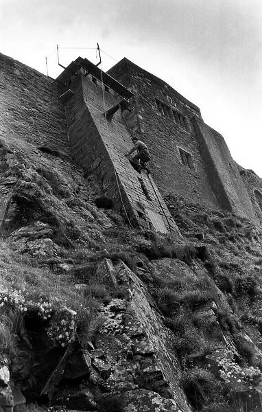 Steeplejack David Stone at work on Lindisfarne Castle on 10th November 1988