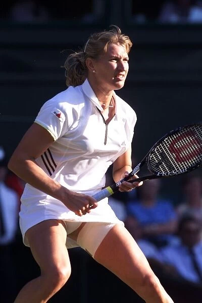 Steffi Graf tennis player at Wimbledon July 1999 with a strapped thigh while playing with