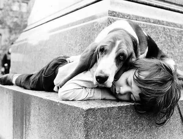 Stephen Durham sleeping with pet Basset hound Sadie. 1972