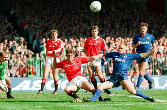 Framed Print : Steve Bruce tries to keep out Andy Ritchie. FA Cup. Manchester United 3 v Oldham Athletic Framed Print : Steve Bruce tries to keep out Andy Ritchie. FA Cup. Manchester United 3 v Oldham Athletic