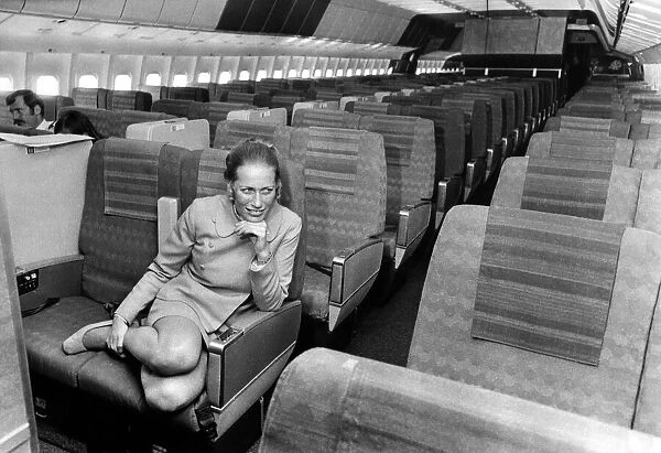 Stewardess Jane Ridley sits in the huge cabin of a Lockheed Tri-Star airliner named