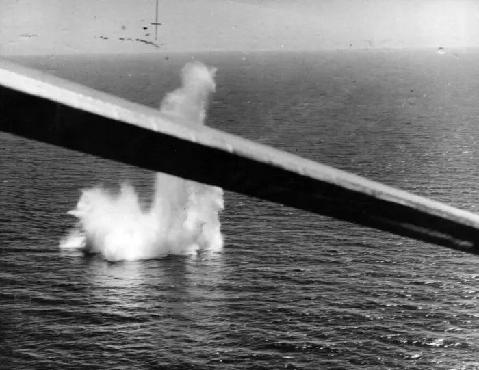 Framed Print : A stick of bombs from a Sunderland aircraft damaging a submarine in the western