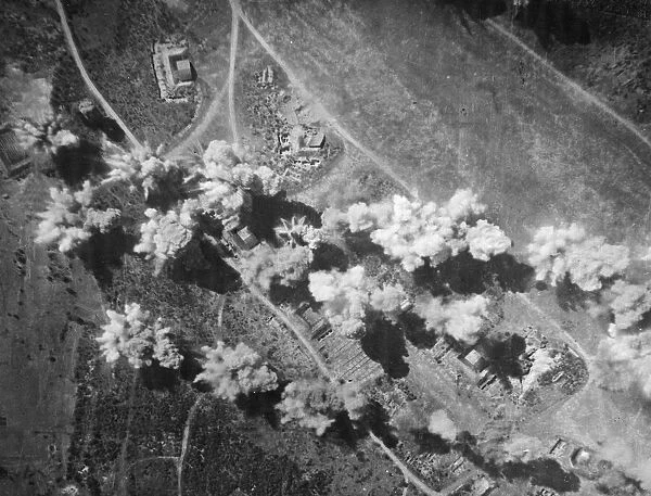 Sticks of bombs explode on and around hangars, dispersal points