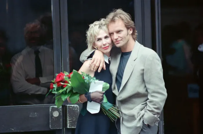 Framed Print : Sting holds and his bride Trudie Styler outside Camden register office, London