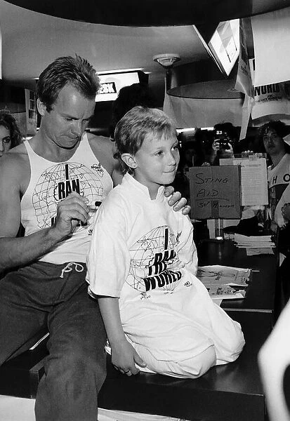 Sting former lead singer with pop group The Police signing youngsters shoulder before
