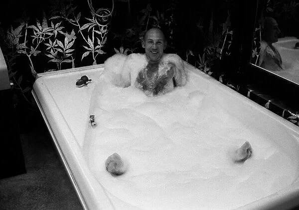 Stirling Moss in bath at his new home 1978