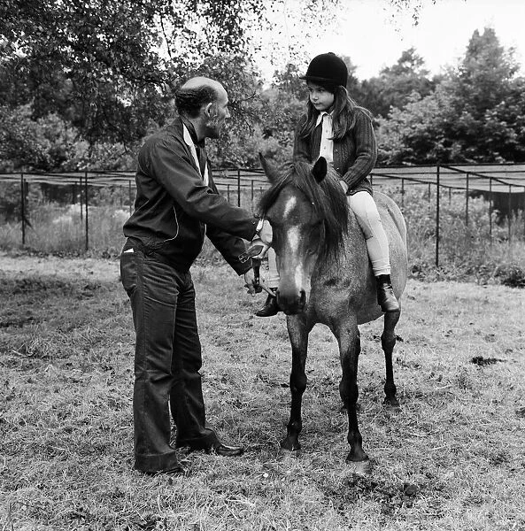 Stirling Moss and his daughter Allison (aged 7) with her horse Happy