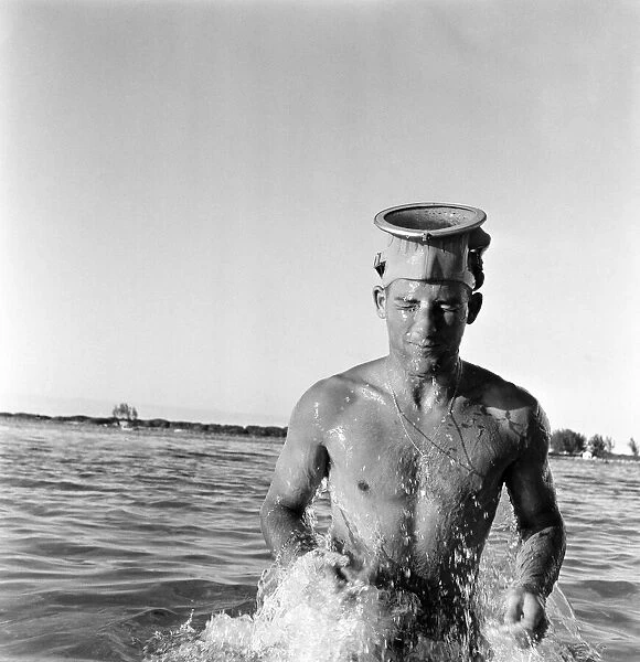 Stirling Moss getting fit by water skiing on the beach at Nassau