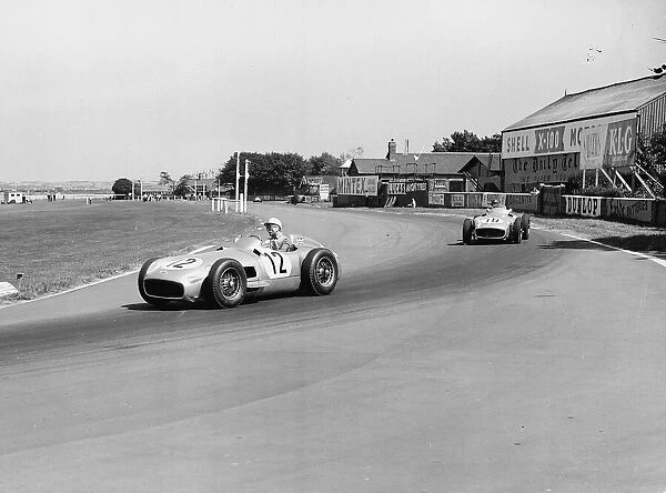 Stirling Moss leading Juan Fangio at the British Grand Prix at Aintree in Liverpool 1955