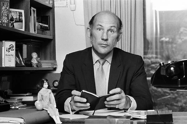 Stirling Moss pictured in his office  /  home in Shepherds Market, London. 3rd August 1973