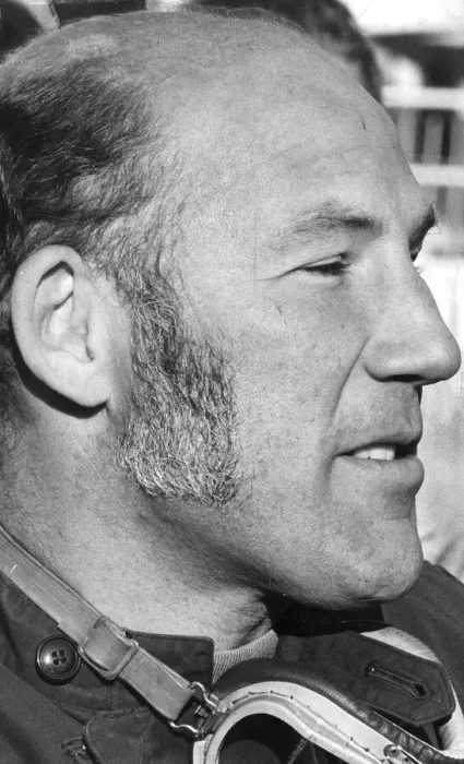 Framed Print : Stirling Moss in profile serious during interview at track - December 1971 Framed Print : Stirling Moss in profile serious during interview at track - December 1971