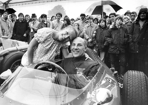 Stirling Moss sitting in Ferrari racing car with wife Suzy standing beside hie at Oulton