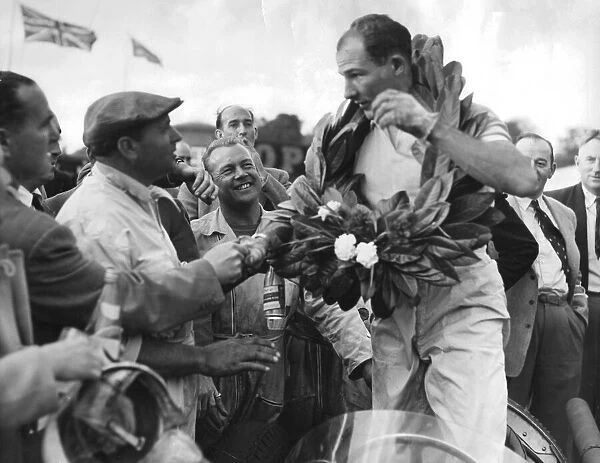 Stirling Moss wearing victory wreath afetr OUlton Park Gold Cup motor race - September
