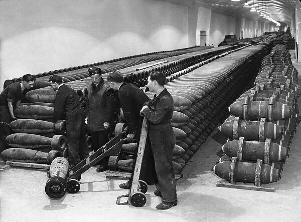 Stockpiles of bombs are loaded for transport from a secret underground munitions dump in