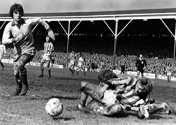 Stoke v. Newcastle. Jimmy Greenhoff lands on top of keeper Mike Mahoney as Glen Keeley