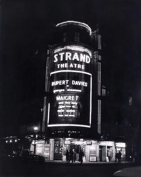 The Strand Theatre London is lit up at night in Neon Lights to advertise the Play '