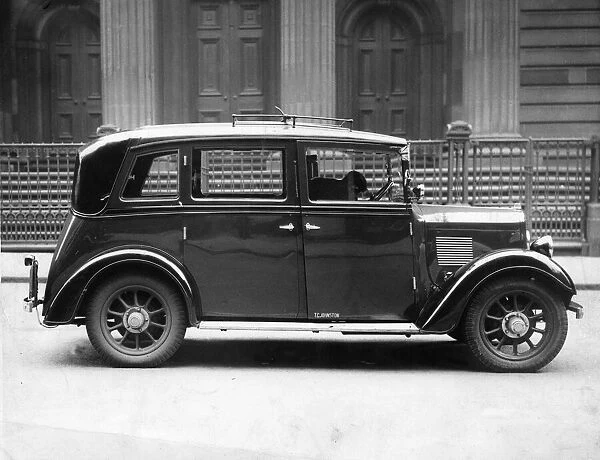 A streamlined Glasgow taxi cab parked in the street. 22nd April 1937