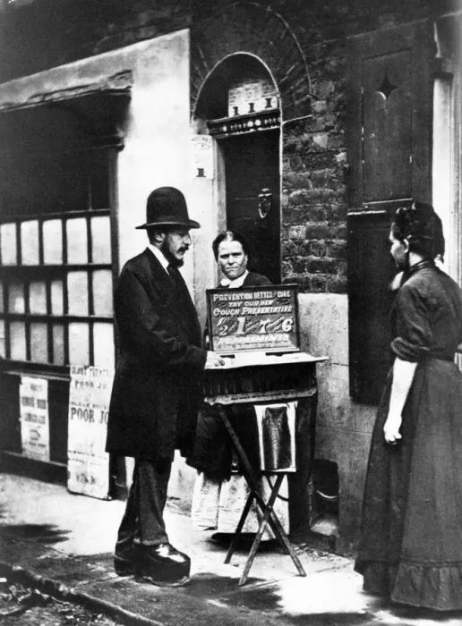 Framed Print : A street pedlar displays his wares in 1870 Framed Print : A street pedlar displays his wares in 1870