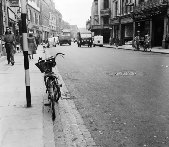 Framed Print : Street scene in Oxford town centre, showing a bicycle parked up against the kerb Framed Print : Street scene in Oxford town centre, showing a bicycle parked up against the kerb