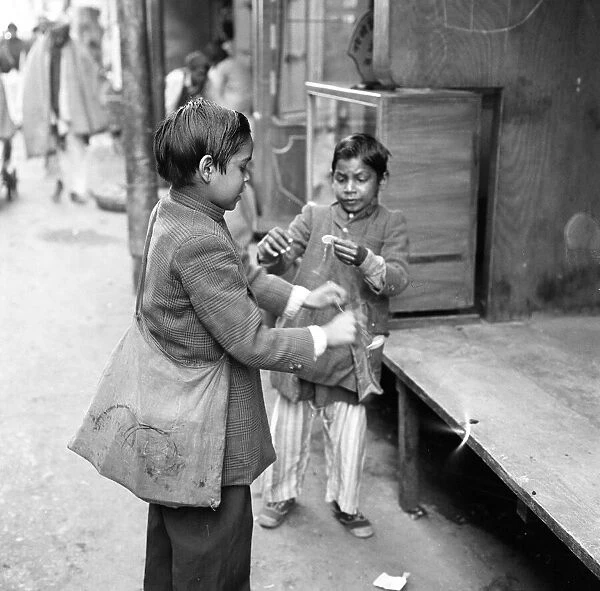 Street scenes, New Delhi, India, January 1961. Two young boys playing in the street