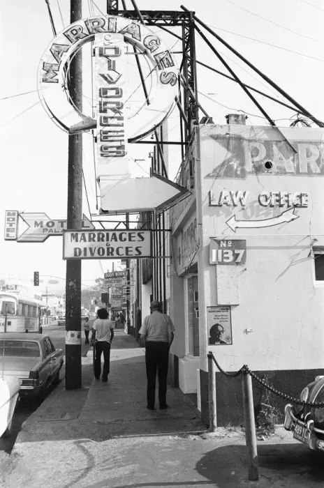 Framed Print : A street in Tijuana, Mexico, with neon signs for bars and quick marriages and divorces