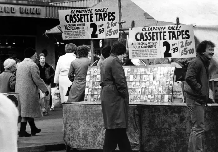 Framed Print : A street trader selling counterfeit cassette tapes from a stall in the Bigg Marker