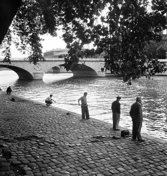 Strike: Frenchmen fishing in the River Seine, Paris during the general strike