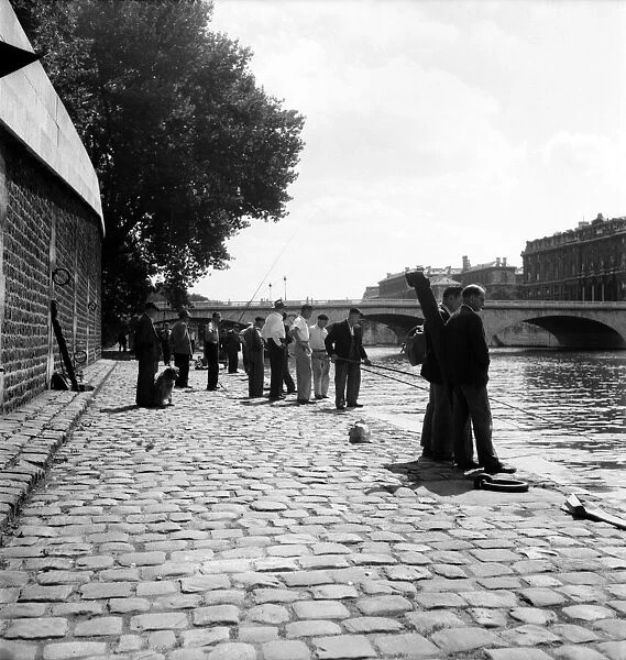 Strike: Frenchmen fishing in the River Seine, Paris during the general strike