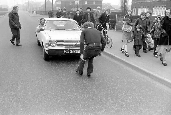 Strongman Reg Morris pulls car and passengers with his teeth. February 1975 75-00777-003