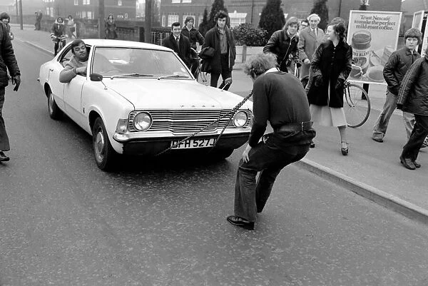 Strongman Reg Morris pulls car and passengers with his teeth. February 1975 75-00777-006