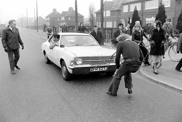 Strongman Reg Morris pulls car and passengers with his teeth. February 1975 75-00777-007
